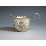 A Victorian Silver Creamer with ribbon and swag decoration, 5.8cm to top of handle, Sheffield