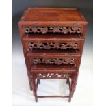 A Chinese Rosewood Nest of Three Tables with carved and pierced foliate apron and stylised bamboo