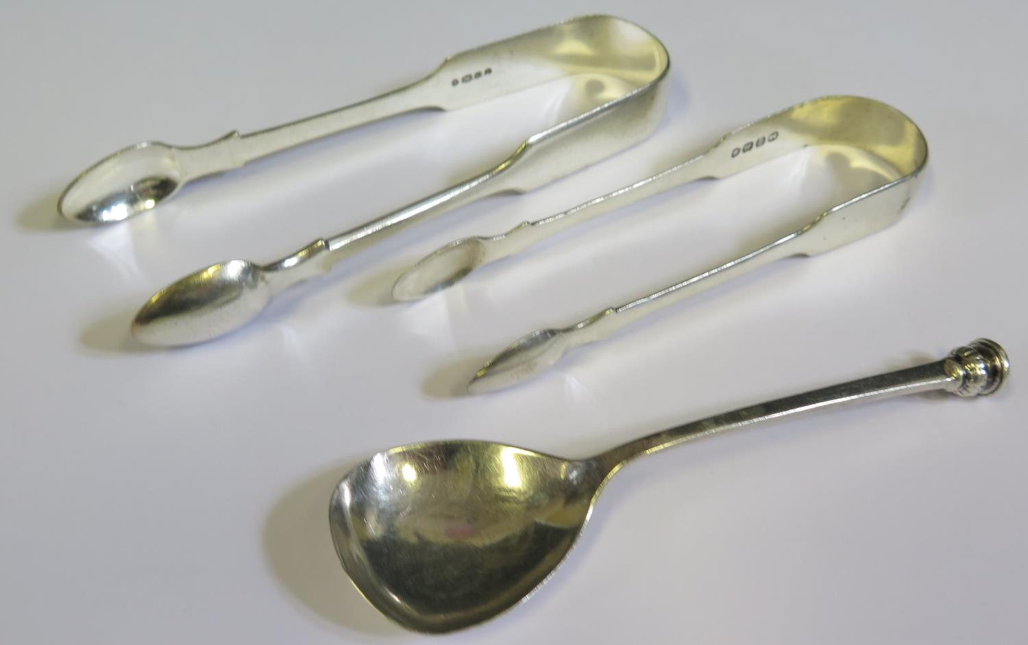 Two Pairs of Sterling Silver Sugar Tongs and a Chester silver spoon
