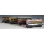 Three Tinplate Hornby Passenger Carriages (two missing wheels) and one other of a different make.