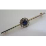 A Sapphire and Diamond Bar Brooch in an unmarked high carat gold setting, 5.8g, sapphire 5.5mm diam.