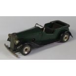 A Triang Minic 19M Vauxhall Open Tourer Car in dark green and black with red base. Motor works.