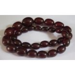 A Faux Cherry Amber Bead Necklace, 57cm, largest bead 27x23mm, 88.8g