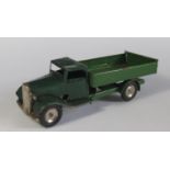 A Triang Minic Clockwork Delivery Lorry with tipping bed in dark green and green. Motor works.