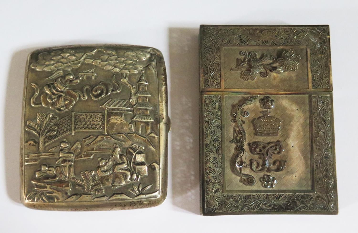 A Chinese Silver Cigarette Case decorated with an embossed landscape scene with figures, the