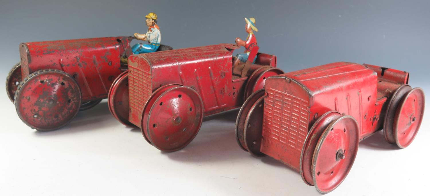 Three Triang Clockwork Tinplate No. 2 Tractors, one motor needs attention.