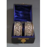 A Cased Pair of Victorian Napkin Rings with embossed foliate scroll decoration, Birmingham 1899,