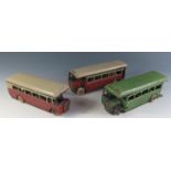 Three early Triang Minic Clockwork 52M Single Deck Buses. Two in maroon and cream and the other in a