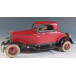 A Chad Valley Ubuilda Clockwork Tinplate Burnett 2 Door Coupe Car in red and black (25.5cm approx)