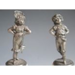 A Pair of Pewter Figurines of a Girl and Boy on alabaster bases, girl 14.5cm high