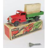 A Triang Minic Clockwork Delivery Lorry in red and green with black hubs. It is in near mint working