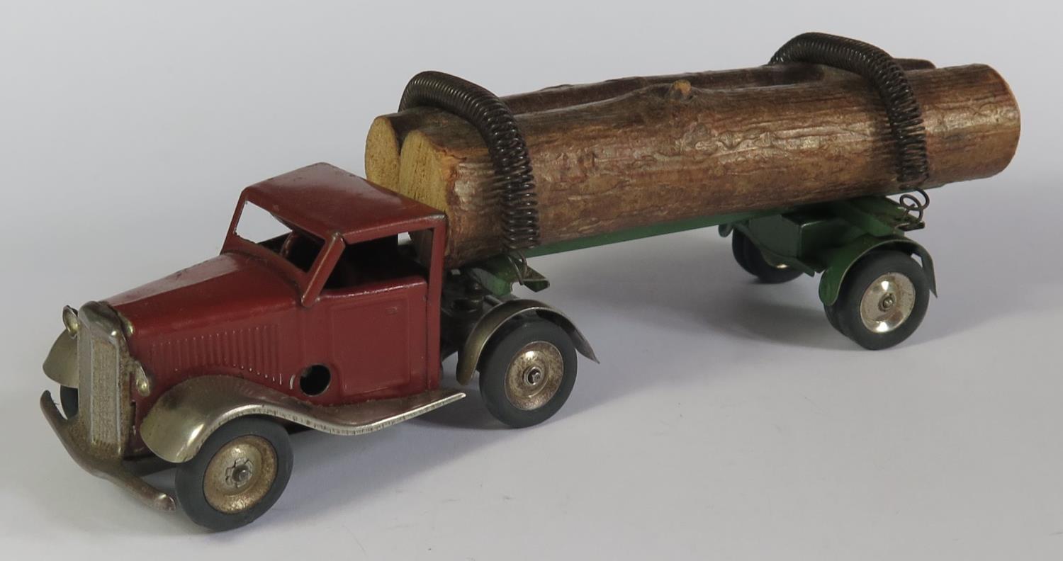 A Triang Minic Clockwork 74M Mechanical Horse and Log Trailer in red/brown and green. Working motor.