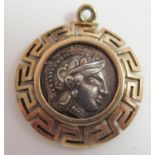 An Unmarked Gold Charm set with a white metal central disc portraying Athena and owl, 2.9g, 20mm