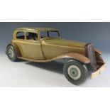 A Large Scale Mettoy Clockwork Tinplate Car in Olive Green with cream detailing and light brown