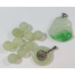 A Chinese Carved Jadeite Buddha Pendant (26mm wide), one other carved pendant and carved beads