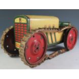 A Scarce German Made Essdee Clockwork Tinplate Tractor with caterpillar tracks in cream, green and
