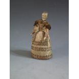 An Early 18th Century Doll Pin Cushion with painted wooden head and jointed arms, 11.5cm tall