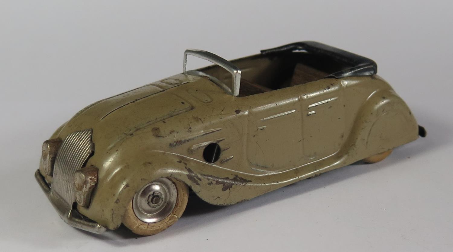 A Triang Minic 14M Streamlined Sports Tourer (Chrysler Airflow) in grey with black base. Motor work