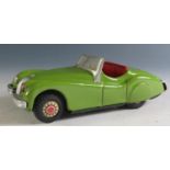 An 1950's Alps Tinplate Jaguar XK 120 in Green with working push n' go motor Made in Japan (16cm