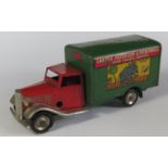 A Triang Minic Clockwork 22M Delivery Van in red and green with decals "Carter Peterson &