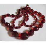 A Graduated Faceted Faux Cherry Amber Bead Necklace, 67cm, 32.1g
