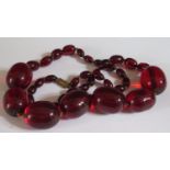 A Faux Cherry Amber Bead Necklace, 56cm, largest bead 25x20mm, 63.6g