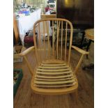 An Ercol Light Elm Spindle Back Open Arm Chair