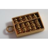 An Unmarked Gold Charm in the form of an abacus, 1.2g, 14mm