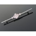An Art Deco Diamond Bar Brooch in an 18ct White Gold and Platinum Setting with round and baguette