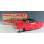 A Kanto Toys Honk-Along Tinplate Lincoln in red and black in original box Made in Japan. The push