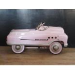 A 1950's Style Metal Super Sports Pedal Car in Pink (100cm approx).