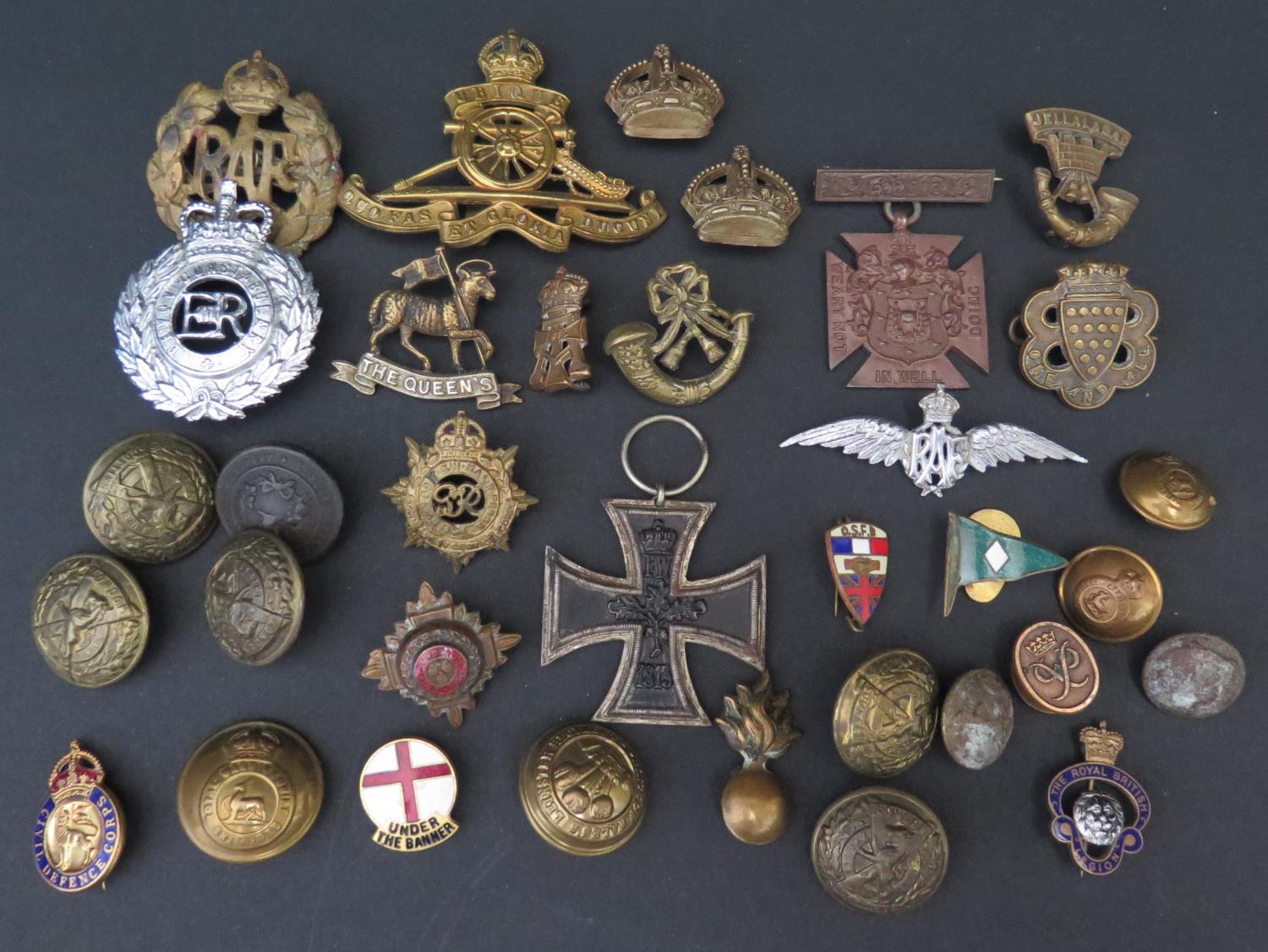 A Collection of Army Cap Badges including The Queens, Iron Cross, buttons etc.