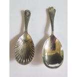 An Edward VII Silver Caddy Spoon with scalloped bowl Sheffield 1903 W.H and one other Sheffield 1959