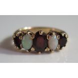 A 9ct Gold, Opal and Garnet Five Stone Ring, size N, 3.8g