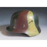 A German M35 Helmet with camouflage paint and SS motif, stamped mark unclear