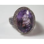An 18ct White Gold Amethyst and Diamond Dress Ring, size R.5, 19.3g, central stone 20x15mm