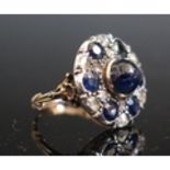 An Antique Cabochon and Round Cut Sapphire and Rose Cut Diamond Dress Ring in a foliate high carat