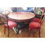 A Victorian Mahogany Tilt Top Circular Dining Table with carved pedestal and tripod base terminating