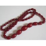 A Faux Amber Bead Necklace, 74cm, largest bead 25x18mm