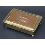 A Brass and Embossed Copper Cigarette Box with plaque to underside of lid "12000 TON ARMOUR PLATE