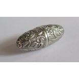 A Miniature Silver Scent Bottle decorated with scrolling foliate work, unmarked, 4cm