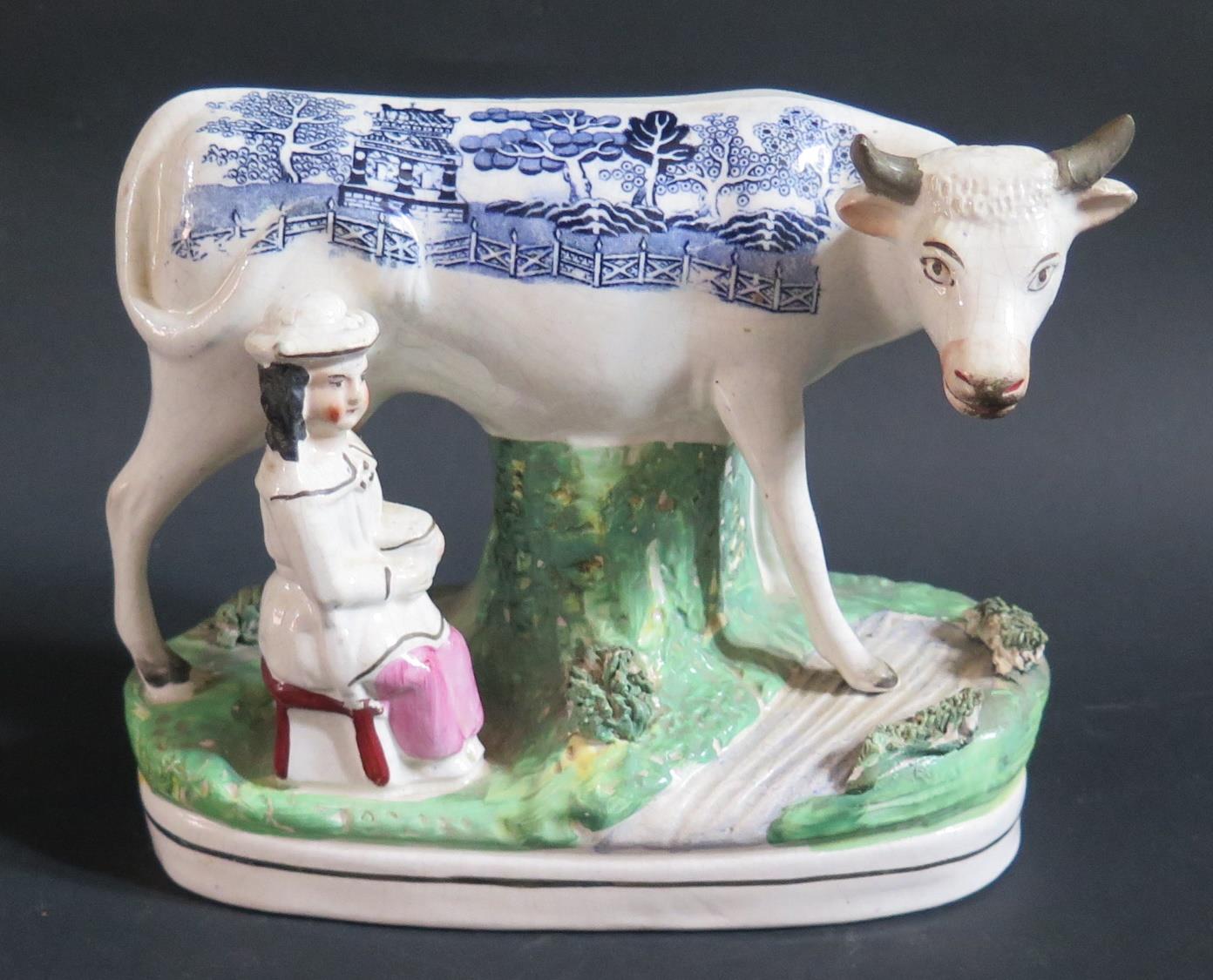 A 19th Century Staffordshire Ornament of cow and maid with blue transfer Willow Pattern