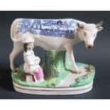 A 19th Century Staffordshire Ornament of cow and maid with blue transfer Willow Pattern