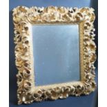 An Early 19th Century Gilt Gesso Framed Mirror decorated with scrolling foliate work, 46x40.5cm