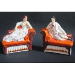 A Pair of 19th Century Staffordshire _ reclining man and woman on chaise longues, c. 19cm long