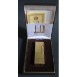 A Dunhill Gold Plated Lighter, cased and with guarantee papers, flint working, but out of gas