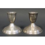 A Pair of Loaded Silver Candlesticks (8cm) and pair of sterling silver mounted glass ashtrays