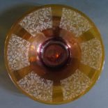 An Amber Glass Shallow Bowl with deep acid etched floral decoration, 30cm diam.
