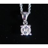 An 18ct White Gold Solitaire Diamond Pendant on a 9ct gold chain, 1.9g