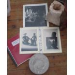 A Black and White Photograph of Martha Allen in her studio, two bound folders illustrating her works